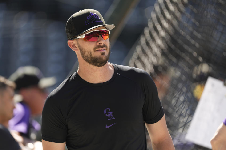 Colorado Rockies' Kris Bryant warms up before a baseball game against the Los Angeles Dodgers, Monday, June 27, 2022, in Denver. (AP Photo/David Zalubowski)