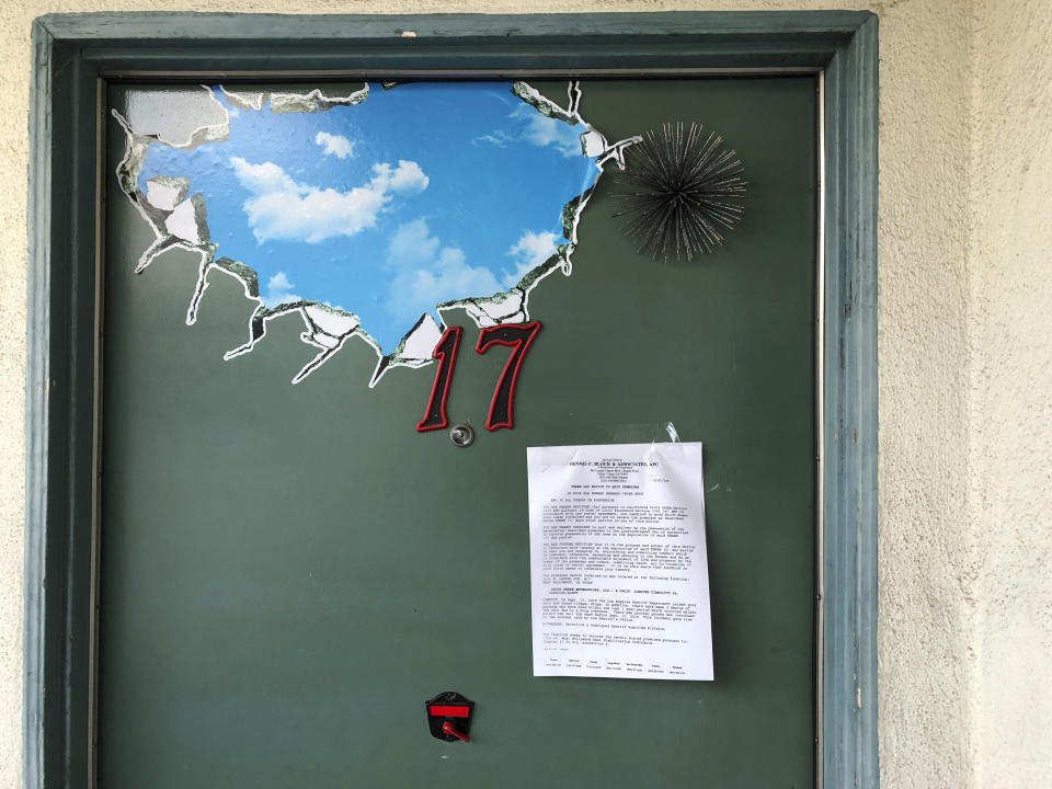 This Sept. 25, 2019 photo shows an eviction notice on the front door of Apartment 17, the home of Democratic donor Ed Buck in West Hollywood, Calif. It took more than two years from the first overdose death in political donor Ed Buck's apartment until his arrest this month. In the time in between, another man died in the West Hollywood home, another had a close brush with death and several others reporting harrowing encounters with the gay white man who preyed on young black men to satisfy a drug-fueled sexual fetish. Activists who pushed for Buck's arrest wonder why it took so long to lock him up. (AP Photo/Brian Melley)