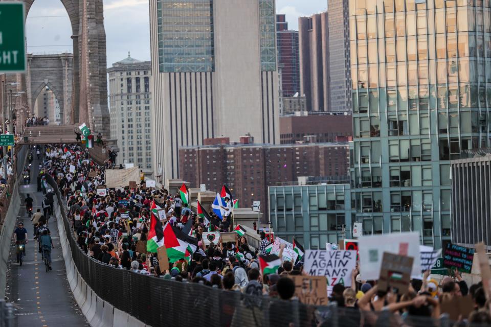 Protesters marching on a bridge in New York City.