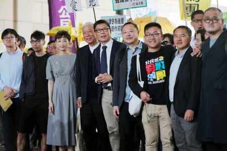 (L-R) Pro-democracy activists Cheung Sau-yin, Chung Yiu-wa, Tanya Chan, Chu Yiu-ming, Chan Kin-man, Benny Tai, Raphael Wong, Lee Wing-tat and Shiu Ka-chun arrive at the court before a verdict on their involvement in the Occupy Central, also known as "Umbrella Movement", in Hong Kong, China April 9, 2019. REUTERS/Tyrone Siu