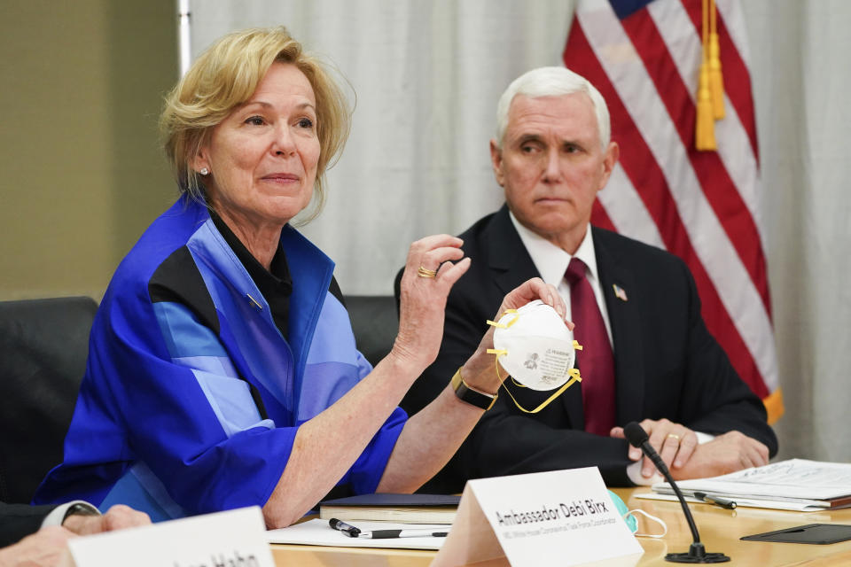 FILE - In this March 5, 2020, file photo, Dr. Deborah Birx, Ambassador and White House coronavirus response coordinator, holds a 3M N95 mask as Vice President Mike Pence visits 3M headquarters in Maplewood, Minn., in a meeting with 3M leaders and Minnesota Gov. Tim Walz to coordinate response to the COVID-19 virus. A review of federal purchasing contracts by The Associated Press shows federal agencies waited until mid-March to begin placing bulk orders of N95 respirator masks, mechanical ventilators and other equipment needed by front-line health care workers. (Glen Stubbe/Star Tribune via AP, File)