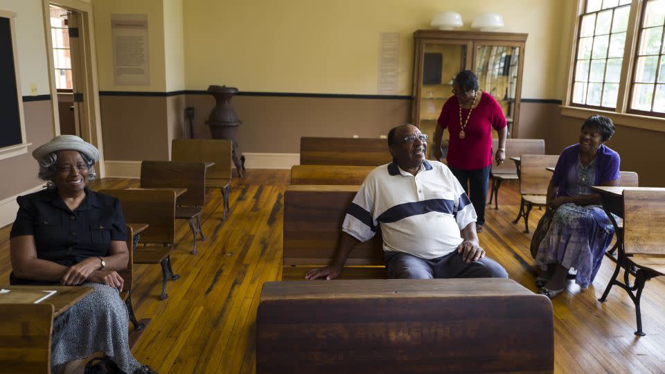 Rosenwald graduates from left, Leonora Gross, 79, Norman Hall, 80, Mae Williams, and Corinthia Ridgley Boone, 80, gather at the Ridgeley School in Capitol Heights, Maryland, in 2015. - Nikki Kahn/The Washington Post/Getty Images