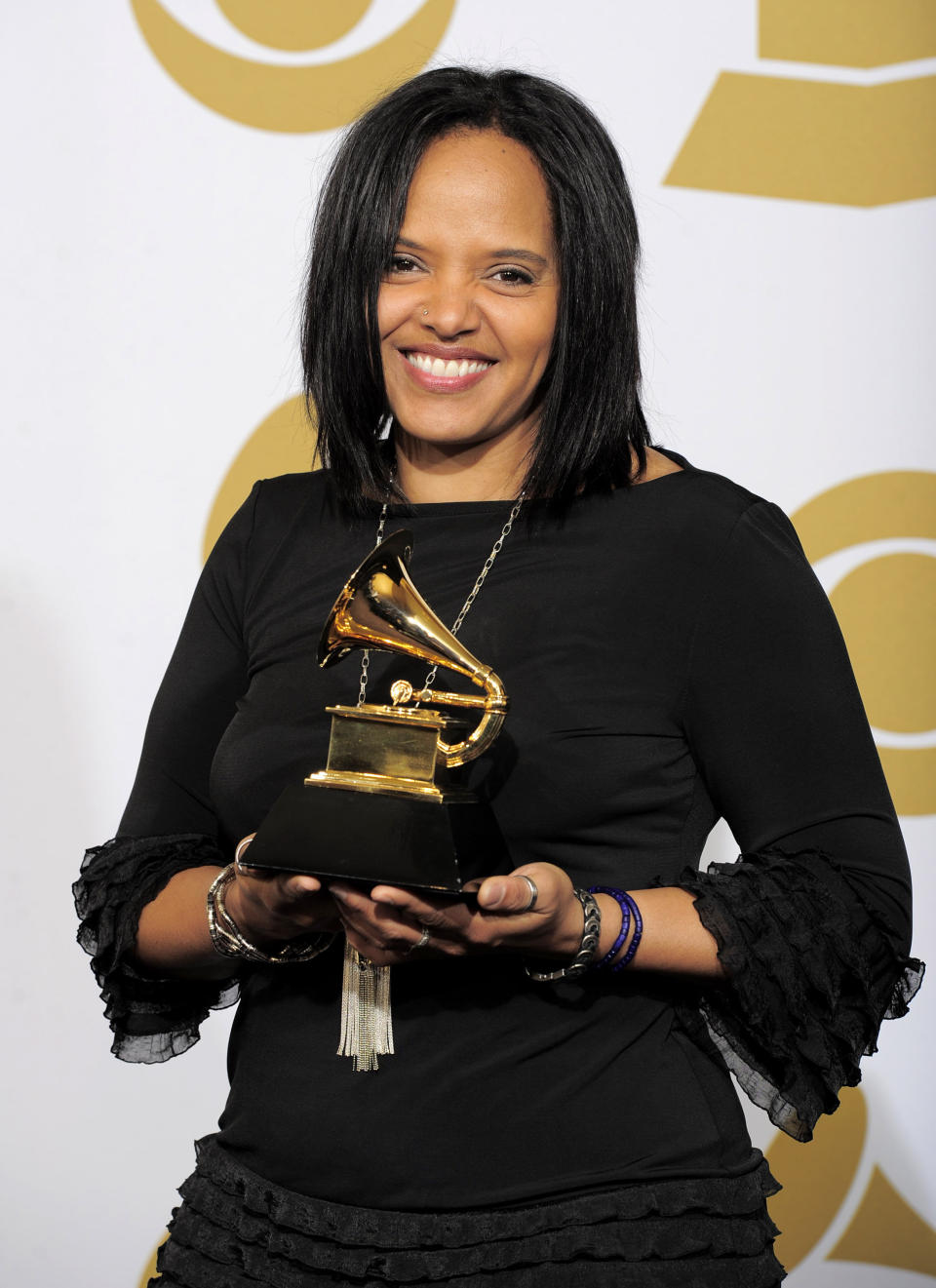 FILE - Terri Lyne Carrington poses backstage with the award for best jazz vocal album for "The Mosaic Project" at the 54th annual Grammy Awards in Los Angeles on Feb. 12, 2012. The three-time Grammy winner is nominated for best instrumental jazz album – an award she won in 2014 and is the only woman to do so in the show’s 63-year history. (AP Photo/Mark J. Terrill, File)