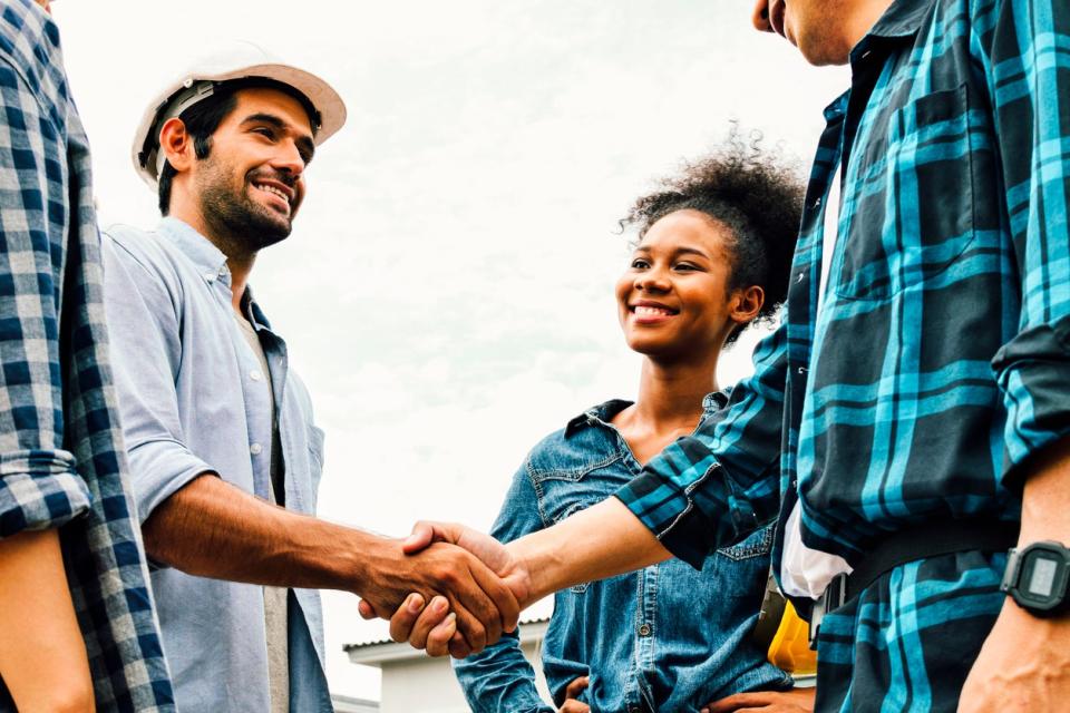 Multi-racial-contractors-shake-hands-and-smile.