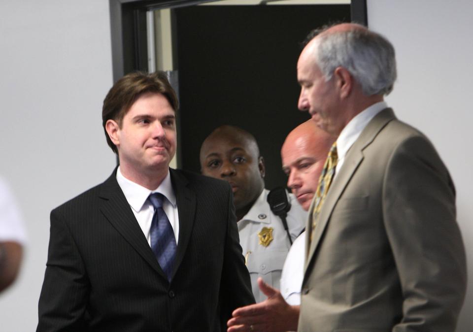 Neil Entwistle acknowledges defense lawyer Elliot Weinstein as they return to the courtroom on June 25, 2008, to hear the jury's decision in a case in which Entwistle was accused of fatally shooting his wife and young daughter. The jury found Entwistle guilty of all charges, including two counts of first-degree murder.