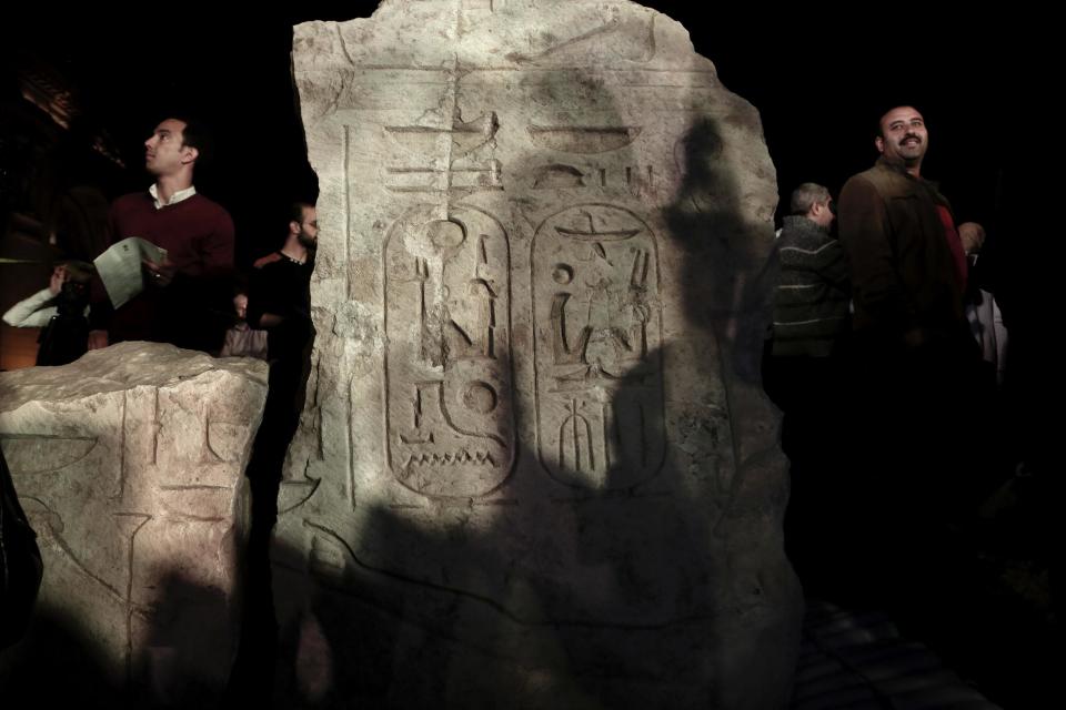 Men gather around a stone part of the statue of King Psamtek l after a press conference at the Egyptian museum in Cairo, Thursday, March 16, 2017. Egypt's antiquities minister Khaled el-Anani, told at a news conference that the colossus discovered last week in an eastern Cairo suburb almost certainly depicts Psamtek I, who ruled Egypt between 664 and 610 B.C. (AP Photo/Nariman El-Mofty)