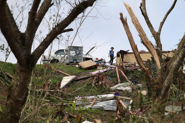 <p>Karlian Mercado,7, walks among the rubble that remains of her families home September 24, 2017 in Hayales de Coamo, Puerto Rico. Puerto Rico experienced widespread damage after Hurricane Maria, a category 4 hurricane, passed through. (Photo: Joe Raedle/Getty Images) </p>