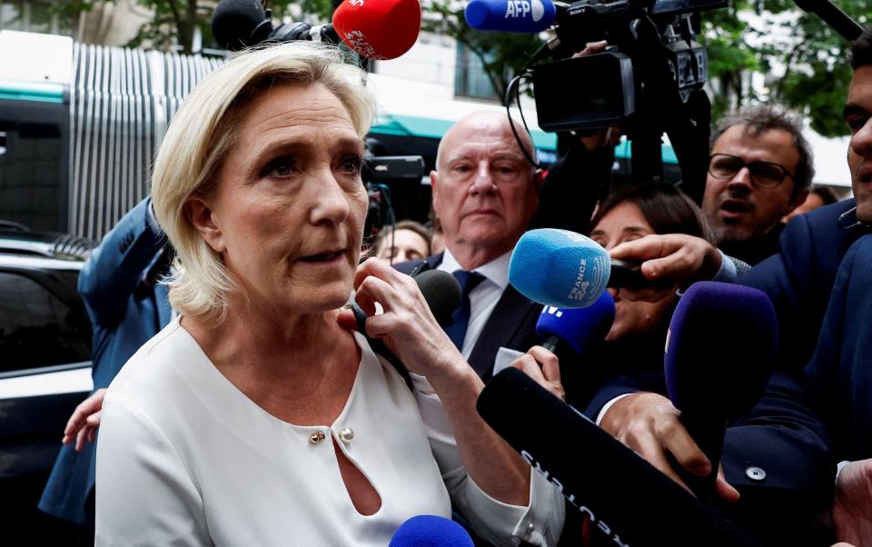 Marine Le Pen speaks to reporters on Monday