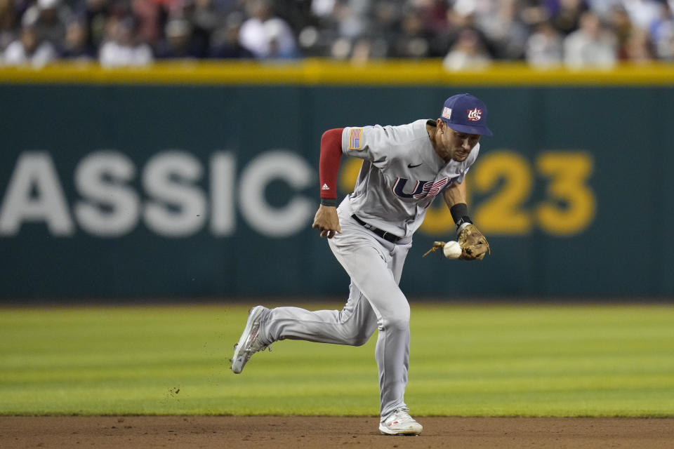 U.S. shortstop Trae Turner bobbles a ball hit by Colombia's Jorge Alfaro, who singled during the third inning of a World Baseball Classic game in Phoenix, Wednesday, March 15, 2023. (AP Photo/Godofredo A. Vásquez)