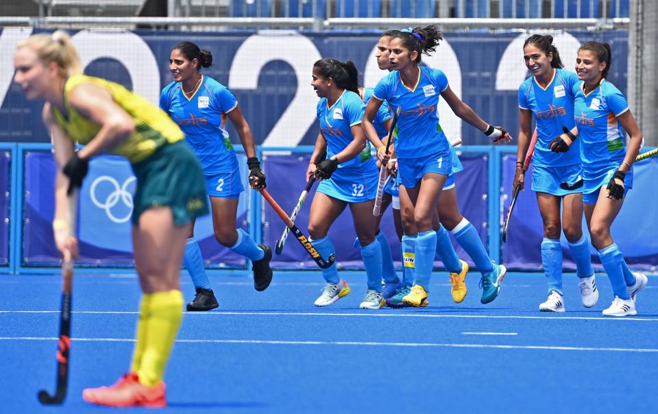 India's Gurjit Kaur (L) celebrates with teammates after scoring against Australia during their women's quarter-final match of the Tokyo 2020 Olympic Games field hockey competition, at the Oi Hockey Stadium in Tokyo, on August 2, 2021. (Photo by CHARLY TRIBALLEAU / AFP) (Photo by CHARLY TRIBALLEAU/AFP via Getty Images)