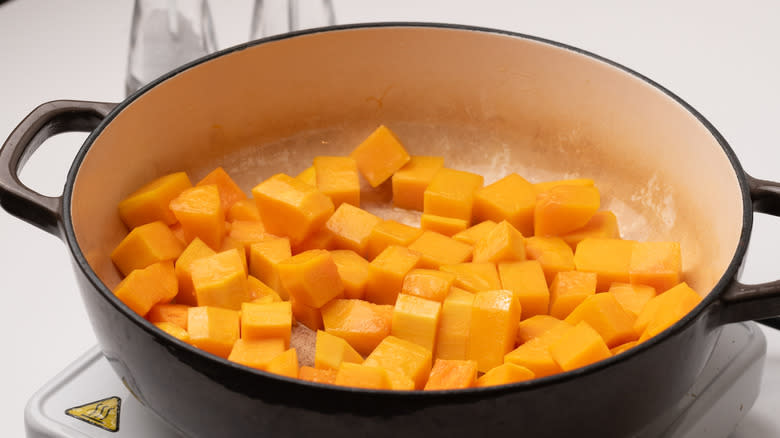 diced pumpkin frying in pan