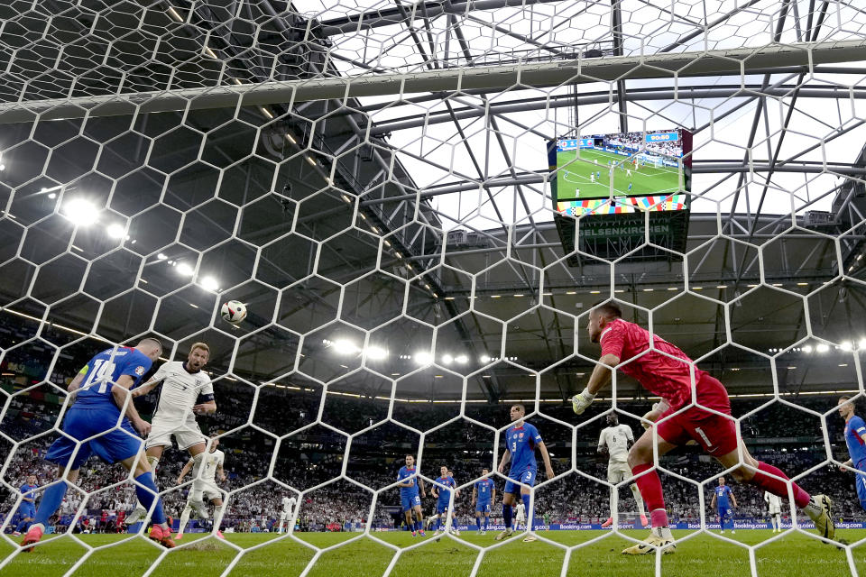 England's Harry Kane, second left, scores his side's second goal during a round of sixteen match between England and Slovakia at the Euro 2024 soccer tournament in Gelsenkirchen, Germany, Sunday, June 30, 2024. (AP Photo/Antonio Calanni)