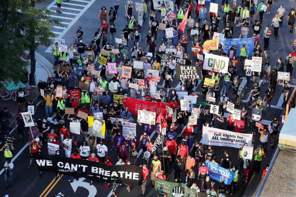 More than 150 people march on State Street toward the Democratic National Convention in Milwaukee on Thursday to protest police killings of Black people and racial injustice.