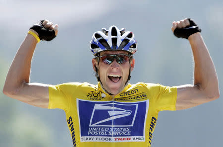 FILE PHOTO: U.S. Postal Service Team rider Lance Armstrong of the United States raises his arms as he crosses the finish line to win the 204.5 km long 17th stage of the Tour de France from Bourd-d'Oisans to Le Grand Bornand, France, July 22, 2004. REUTERS/Wolfgang Rattay/File Photo