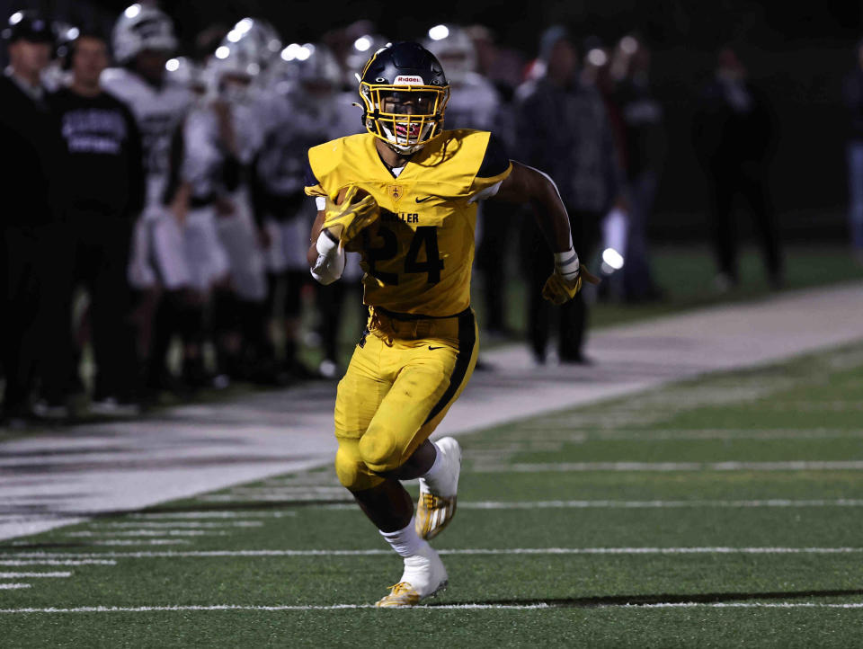 Moeller running back Jordan Marshall  (24) carries the ball during a playoff game between Mason and Moeller high schools Friday, Nov. 11, 2022.