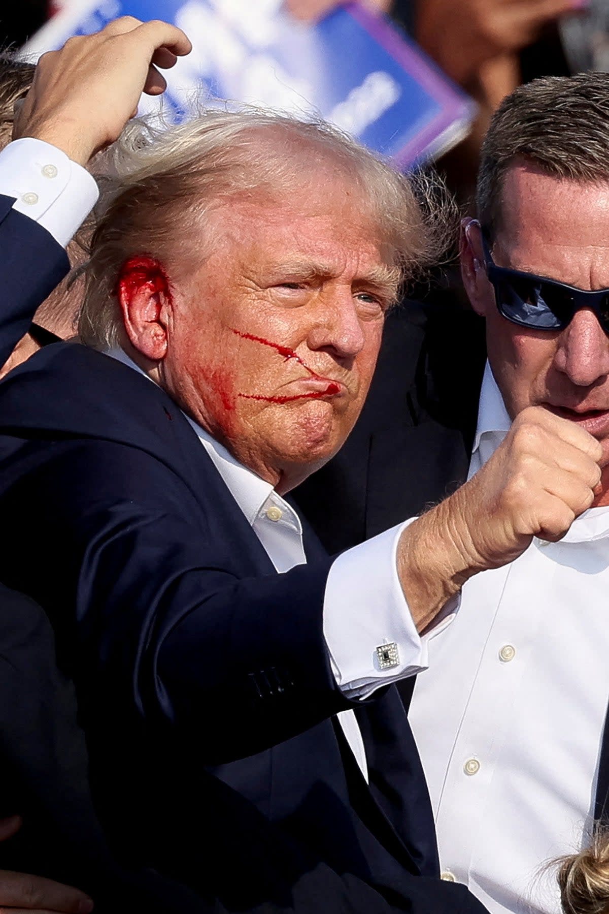 Donald Trump raises his fist to a campaign rally crowd after he appeared to be struck by gunfire on July 13. (REUTERS)