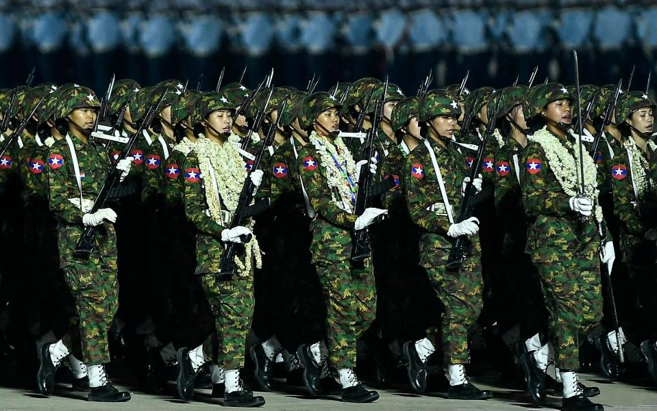 Junta military soldiers parade during a ceremony to mark Myanmar's Armed Forces Day