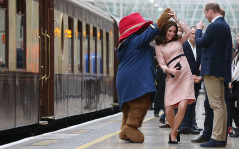 Duchess of Cambridge dances with Paddington bear on platform 1 at Paddington  - Credit: Jonathan Brady /WPA Pool/Getty