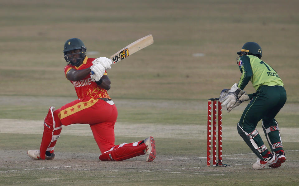 Zimbabwe's batsman Elton Chigumbura, left, follows the ball after playing a shot during their 3rd Twenty20 cricket match against Pakistan at the Pindi Cricket Stadium, in Rawalpindi, Pakistan, Tuesday, Nov. 10, 2020.(AP Photo/Anjum Naveed)