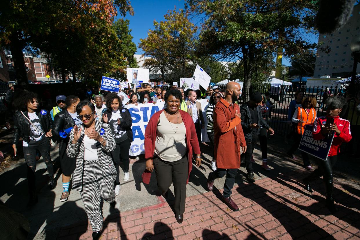 Then-Georgia gubernatorial candidate Stacey Abrams and Grammy-winning artist Common leads voters during a "Souls to the Polls" march in downtown Atlanta on Oct. 28, 2018, in Atlanta. (Photo: Jessica McGowan via Getty Images)