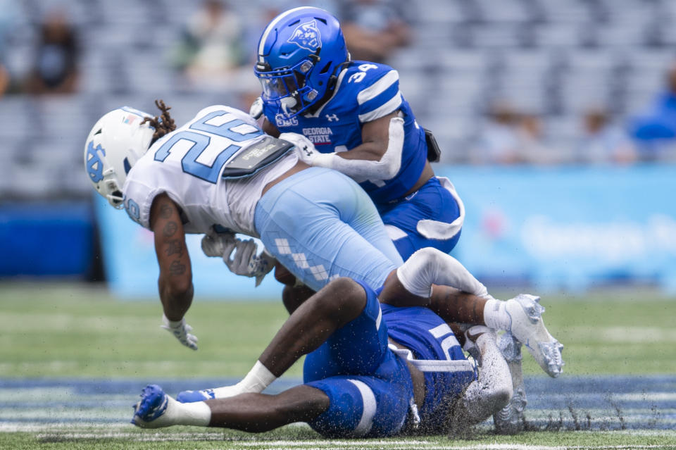 Georgia State linebacker Jacorey Crawford and safety Antavious Lane tackles North Carolina running back D.J. Jones in the second half of an NCAA college football game against Saturday, Sept. 10, 2022, in Atlanta. (AP Photo/Hakim Wright Sr.)