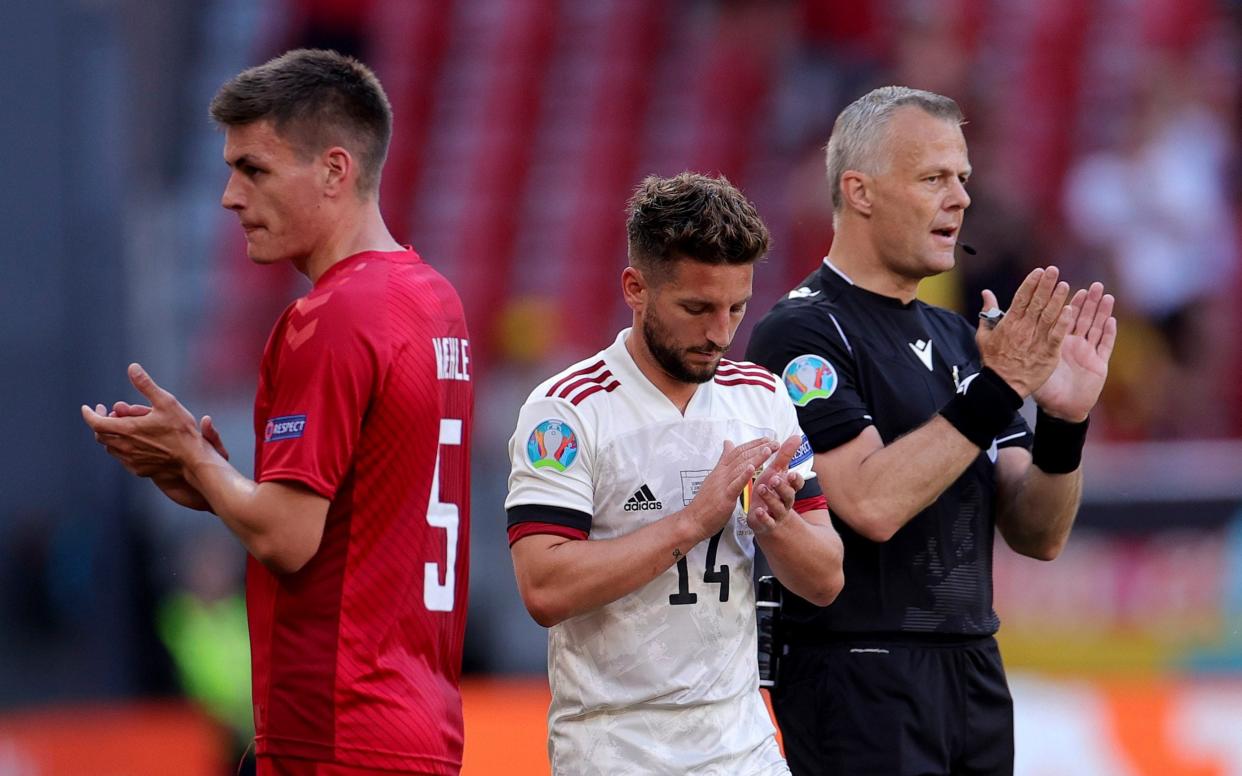 Players and the referee applaud during the break at the tenth minute to honour Denmark's Christian Eriksen during the Euro 2020 soccer championship group B match between Denmark and Belgium at Parken stadium in Copenhagen, Thursday, June 17, 2021.  - AP