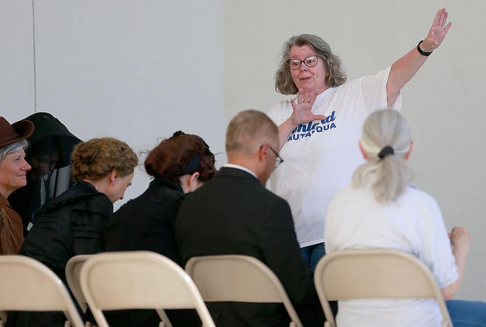 Deleasa Randall-Griffiths greets those in attendance Monday at a preview for this week's Ashland Chautauqua 2022: "The Famous and Infamous" performances at the Myers Band Shell.