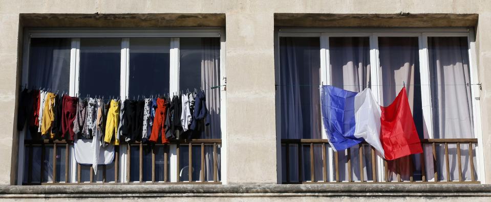 A French national flag hangs from a balcony in Marseille, France, November 27, 2015 as the French President called on all French citizens to hang the tricolour national flag from their windows on Friday to pay tribute to the victims of the Paris attacks during a national day of homage. (REUTERS/Jean-Paul Pelissier)