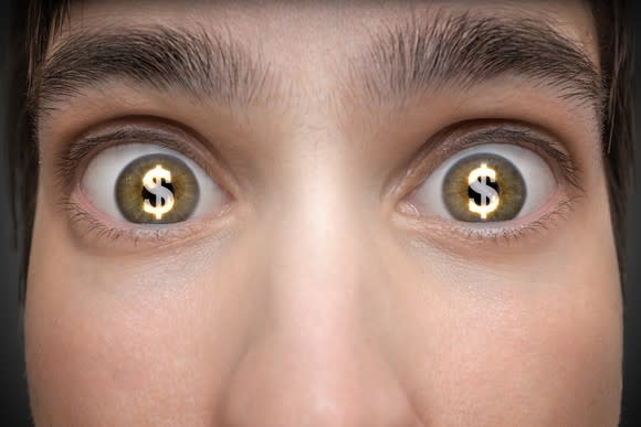 Dollar signs in eyes of young person