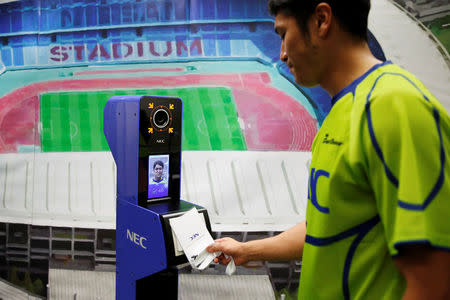 NEC Green Rockets' rugby player Teruya Goto demonstrates the face recognition system for Tokyo 2020 Olympics and Paralympics, which is developed by NEC corp, in Tokyo, Japan August 7, 2018. REUTERS/Toru Hanai