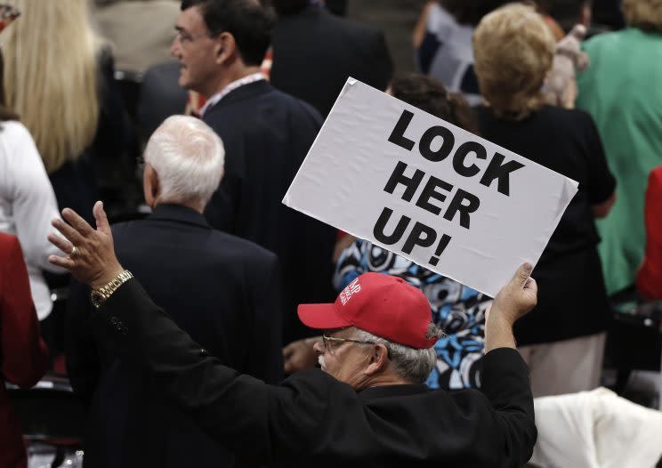 A delegate holds a sign demanding that Democratic presidential candidate Hillary Clinton be jailed. (Photo: Mike Segar/Reuters)