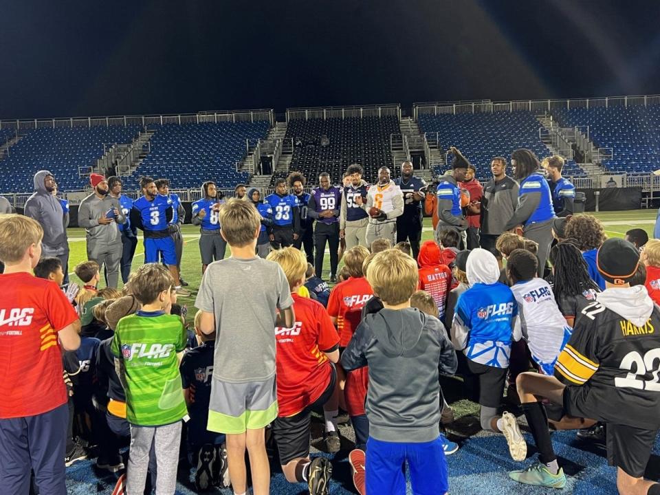 Youth participants listen to introductions of players in the Reese's Senior Bowl, who joined with UWF players to stage free youth football clinic Jan. 25 at UWF's Pen-Air Field.