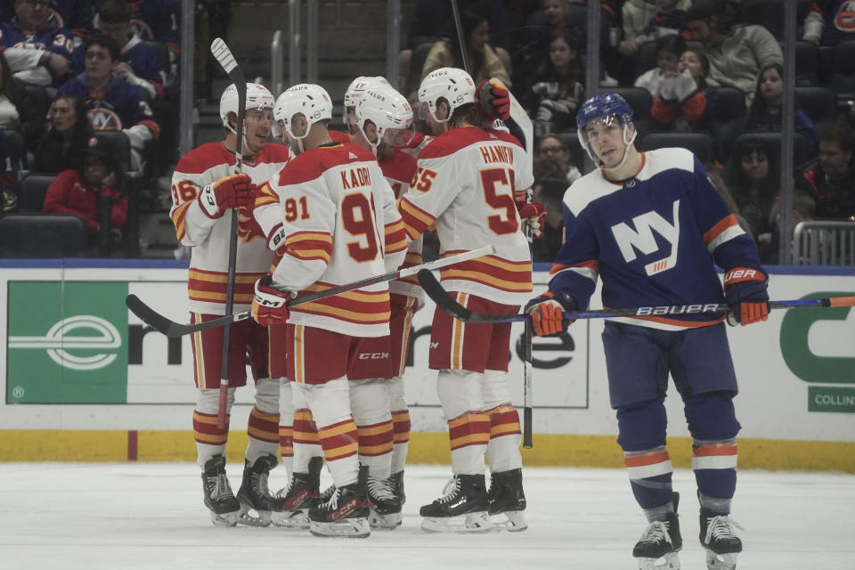 Calgary Flames players celebrates a goal during the second period of an NHL hockey game against the New York Islanders, Saturday, Feb. 10, 2024, in New York. (AP Photo/Bebeto Matthews)