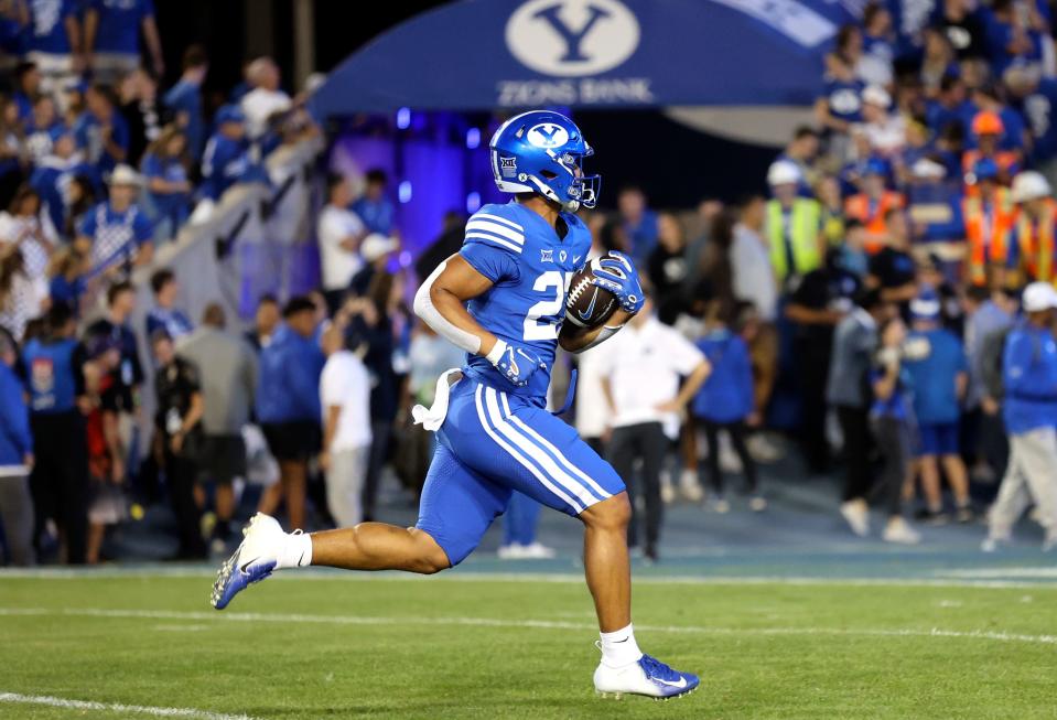 Players warm up before the Brigham Young Cougars play the Cincinnati Bearcats at LaVell Edwards Stadium in Provo on Friday, Sept. 29, 2023. | Kristin Murphy, Deseret News