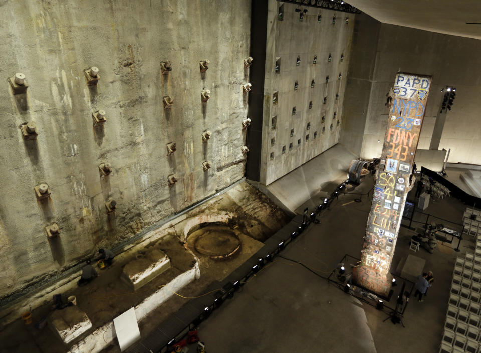 A portion of the World Trade Center slurry wall, left, and the symbolic last beam, are displayed at the National Sept. 11 Memorial Museum, Wednesday, May 14, 2014, in New York. The museum is a monument to how the Sept. 11 terror attacks shaped history, from its heart-wrenching artifacts to the underground space that houses them amid the remnants of the fallen twin towers' foundations. It also reflects the complexity of crafting a public understanding of the terrorist attacks and reconceiving ground zero. (AP Photo)