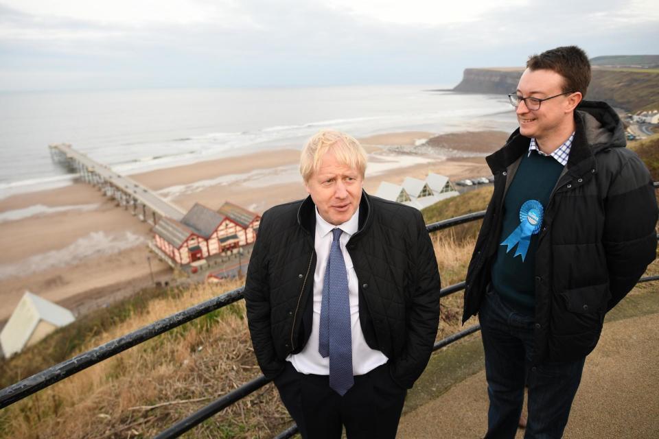 Simon Clarke stands next to Boris Johnson in Saltburn-by-the-Sea (PA)