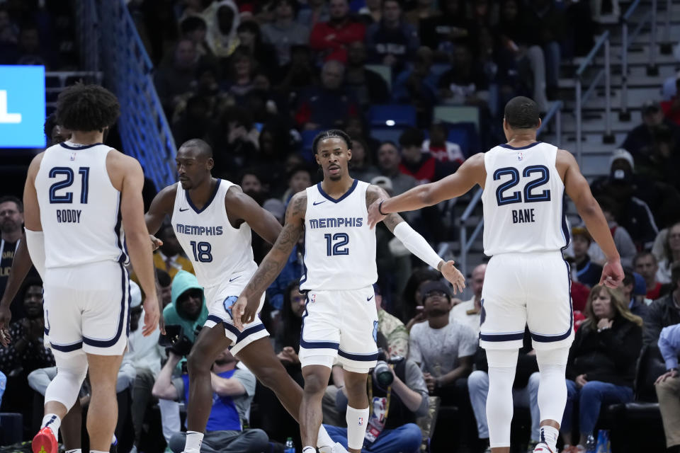 Memphis Grizzlies guard Ja Morant (12) celebrates with teammates in the second half of an NBA basketball game against the New Orleans Pelicans in New Orleans, Tuesday, Dec. 19, 2023. The Grizzlies won 115-113. (AP Photo/Gerald Herbert)