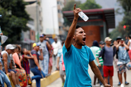 A demonstrator gestures at a protest against the government of Venezuelan President Nicolas Maduro in Caracas, Venezuela March 31, 2019. REUTERS/Carlos Garcia Rawlins