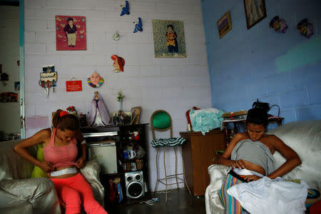 Alejandra Jordan (R), 30, and her sister Andreina Jordan, 34, recover after sterilization surgery at their home in San Francisco de Yare, Venezuela July 28, 2016. REUTERS/Carlos Garcia Rawlins