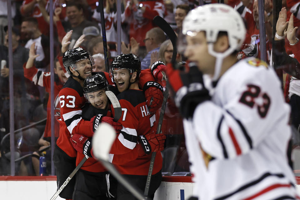 New Jersey Devils defenseman Dougie Hamilton (7) celebrates with teammates after scoring a goal against the Chicago Blackhawks during the first period of an NHL hockey game Friday, Oct. 15, 2021, in Newark, N.J. (AP Photo/Adam Hunger)