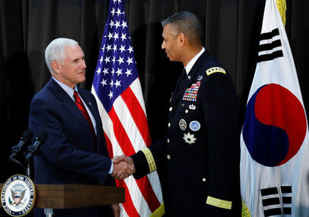 U.S. Vice President Mike Pence shakes hands with commander General Vincent K. Brooks during an Easter fellowship dinner at a military base in Seoul, South Korea, April 16, 2017. REUTERS/Kim Hong-Ji