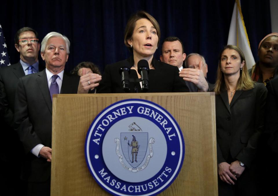 Massachusetts Attorney General Maura Healey, center, takes questions from reporters during a news conference Tuesday, Jan. 31, 2017, in Boston. Healey is joining a lawsuit filed by the American Civil Liberties Union of Massachusetts challenging President Donald Trump's executive order on immigration. Martin Meehan, president of the University of Massachusetts, stands second from left. (AP Photo/Steven Senne)