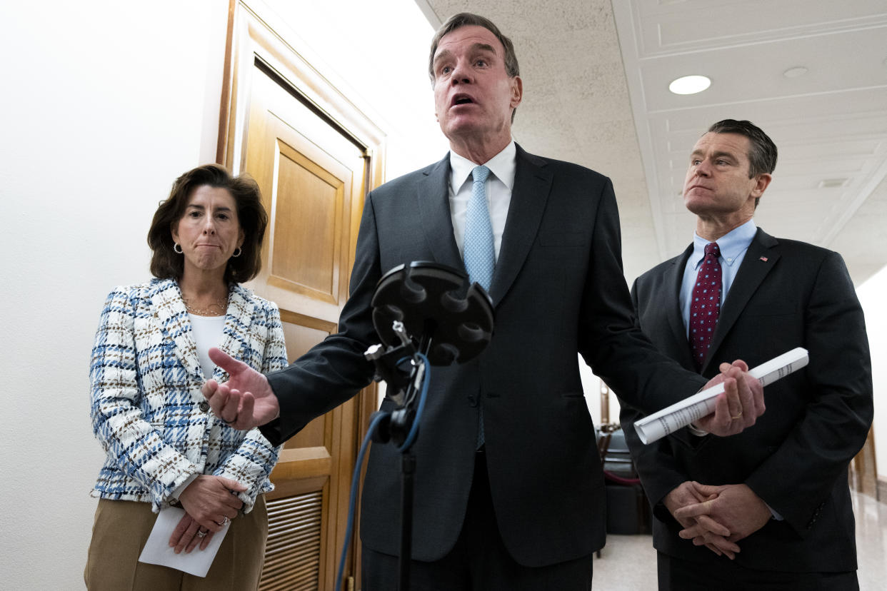 Commerce Secretary Gina Raimondo, Sen. Mark Warner, and Sen. Todd Young discuss the Bipartisan Innovation Act on March 22, 2022. (Bill Clark/CQ-Roll Call, Inc via Getty Images)