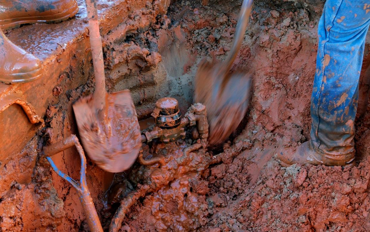 Shovels wielded by Edmond field service workers expose a water meter next to a broken service line on Oct. 16.