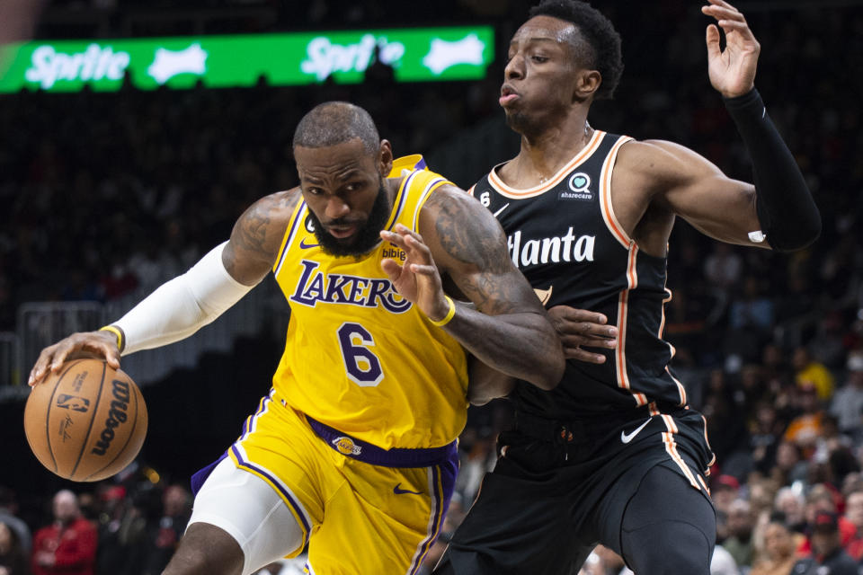 Los Angeles Lakers forward LeBron James drives against Atlanta Hawks forward Onyeka Okongwu during the first half of an NBA basketball game Friday, Dec. 30, 2022, in Atlanta. (AP Photo/Hakim Wright Sr.)