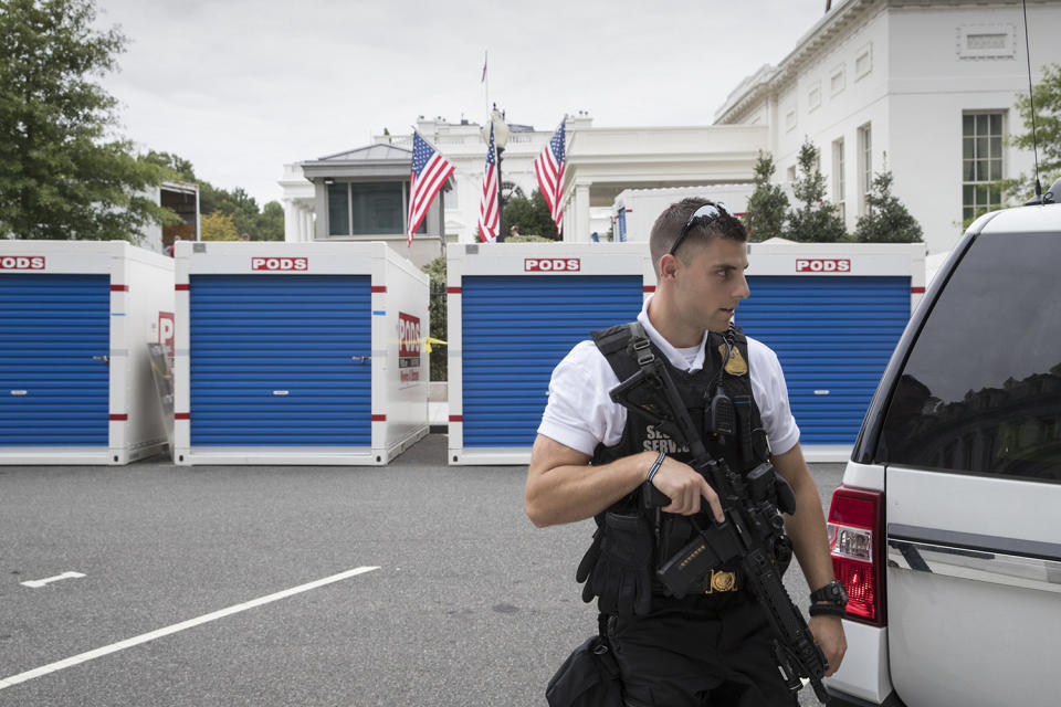 <p>With a Uniformed Secret Service officer standing watch, storage containers line the driveway as the West Wing of the White House in Washington, Friday, Aug. 11, 2017, as it goes through renovations while President Donald Trump is spending time at his golf resort in New Jersey. (AP Photo/J. Scott Applewhite) </p>