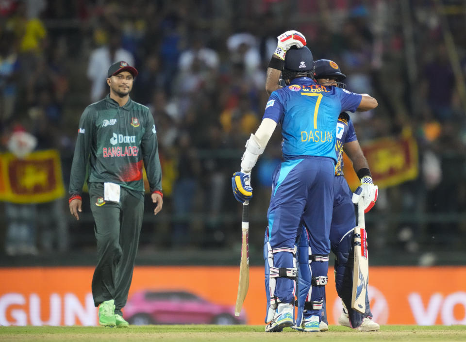 Bangladeshes' captain Shakib Al Hasan, left, watches as Dasun Shanaka and Charith Asalanka celebrate their win in five wickets in the one day international cricket match between Sri Lanka and Bangladesh of Asia Cup in Pallekele, Sri Lanka on Thursday, Aug. 31. (AP Photo/Eranga Jayawardena)