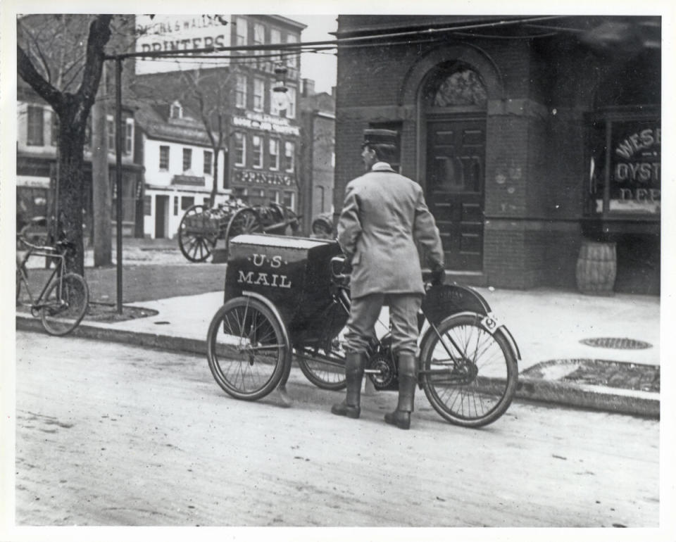 Three wheeled 1912 Indian motorcycle vintage delivering mail postal service