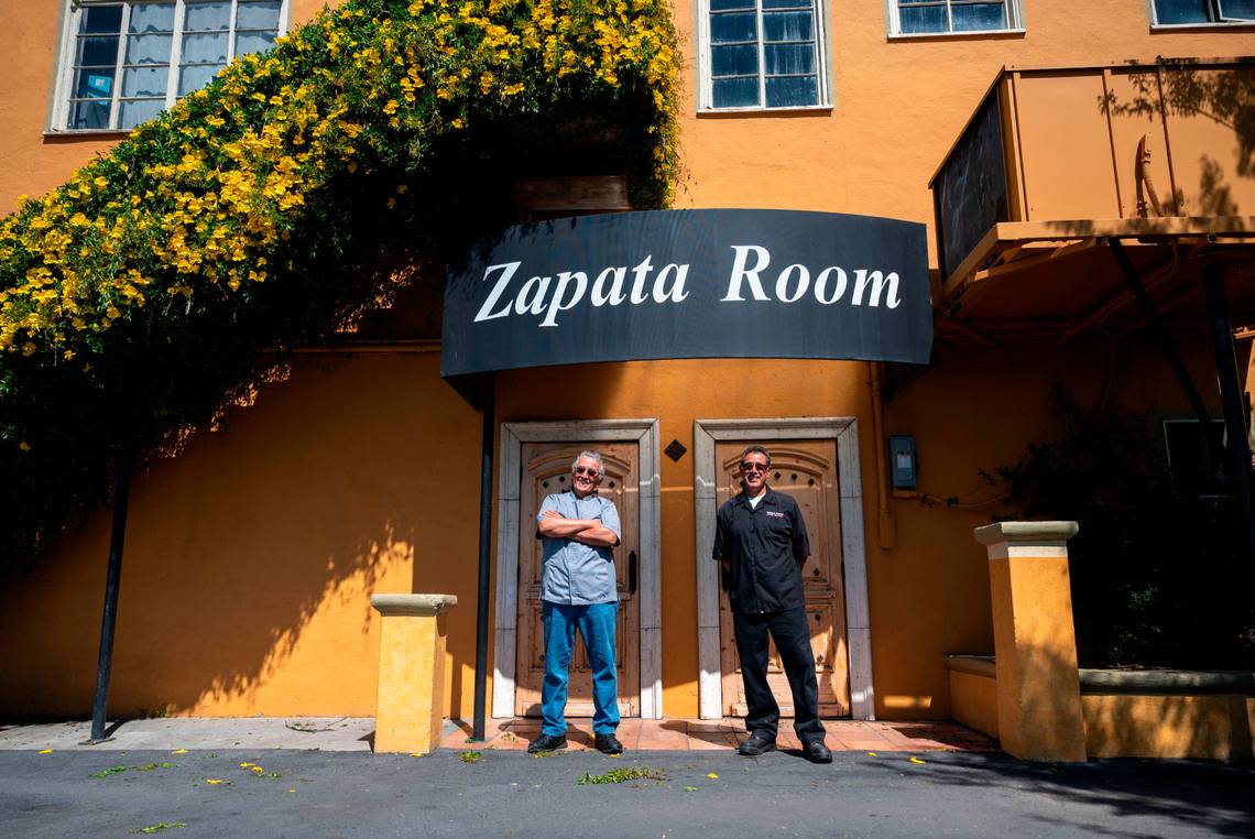 Brothers Ruben and Roy Unzueta, owners of Caballo Blanco restaurant, stand outside their event hall called the Zapata Room on Friday.