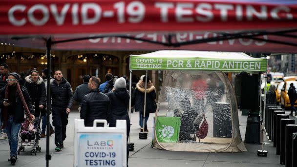 PHOTO: FILE - People walk next to coronavirus disease (COVID-19) testing sites in New York City, Dec. 12, 2022. (Eduardo Munoz/Reuters, FILE)